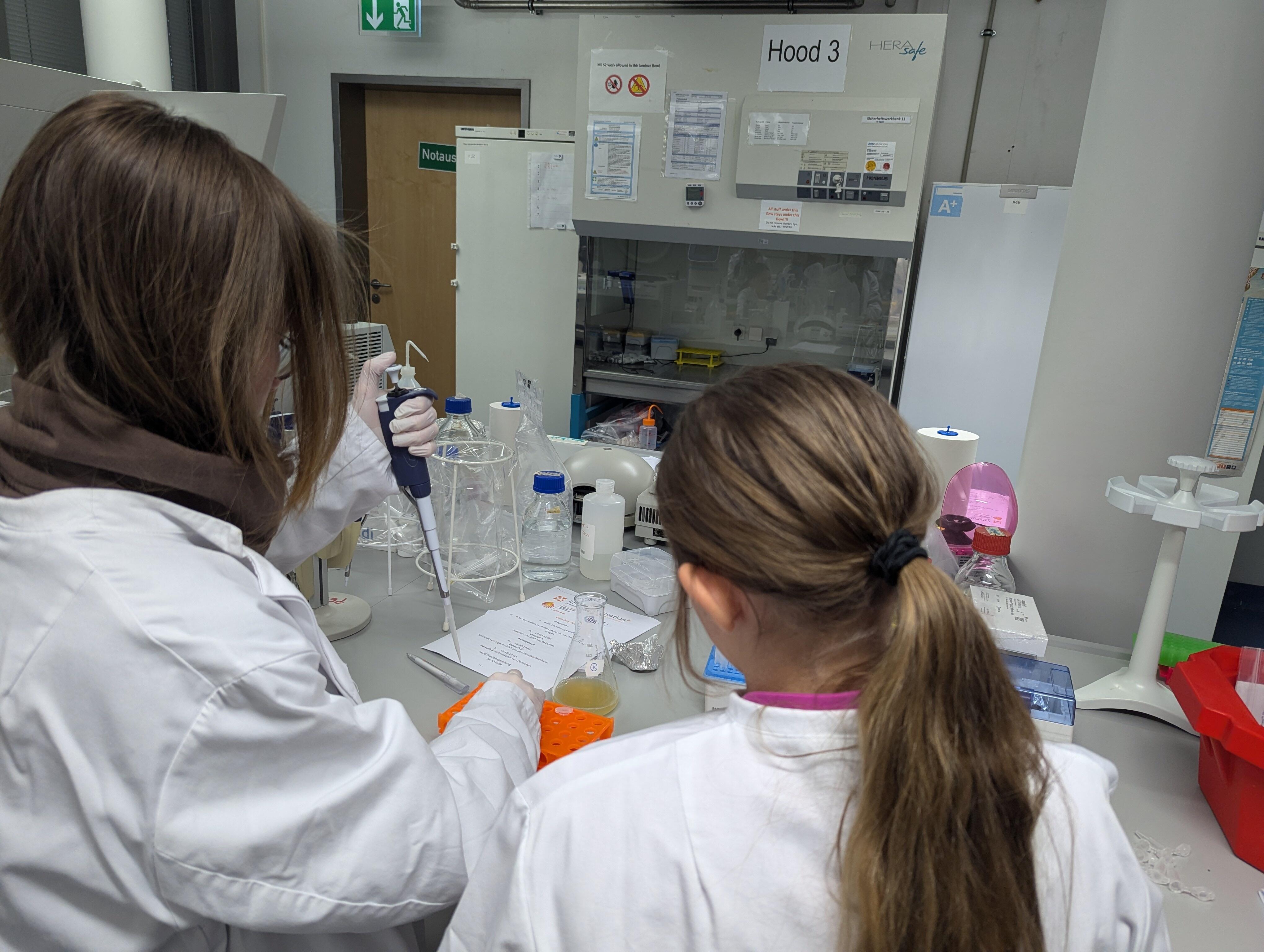 Two girls pipetting