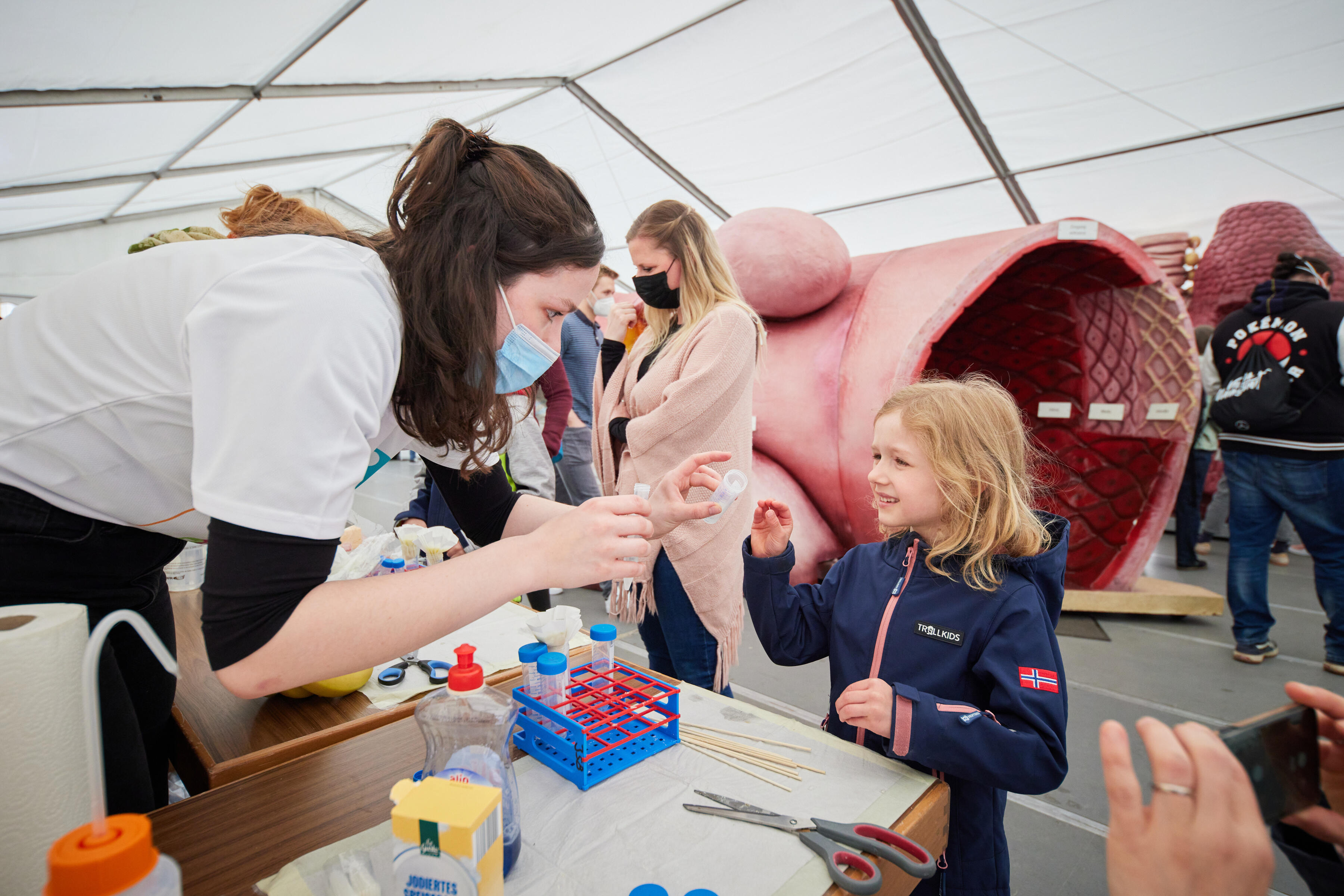 Scientist talking to child